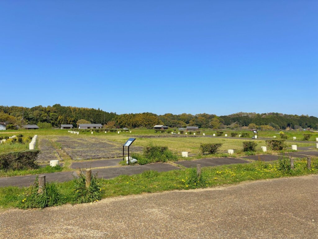 Ruins of the ancient Asuka Palace, the political center of early Japan, surrounded by open fields and blue sky